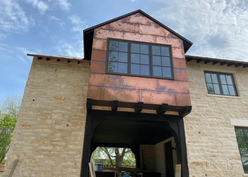 Copper metal panel facade on a stone building for Skylight Installation in Gainesville